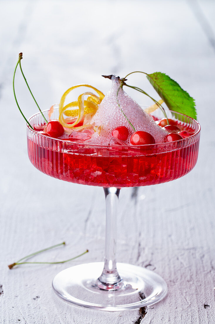 A cherry cocktail with gin, ginger ale and mini wild cherries