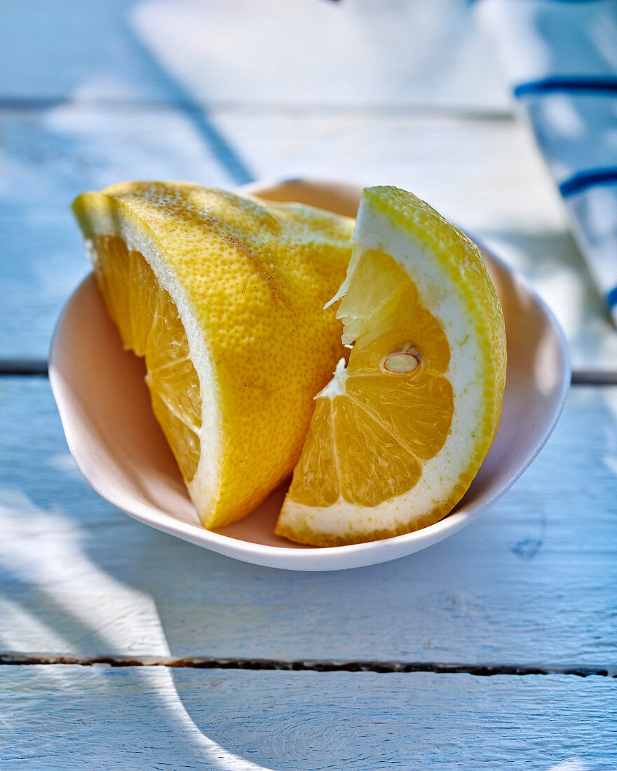Lemon wedges in a white bowl