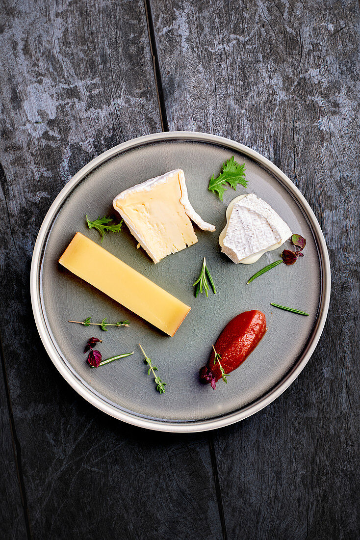A cheese platter with herbs and chilli jam