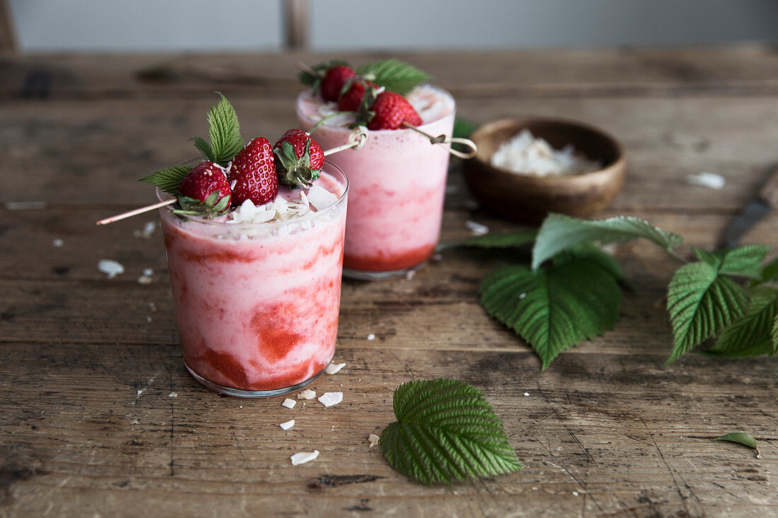 Erdbeercremedessert mit weißen Schokoraspeln und Erdbeerspießchen