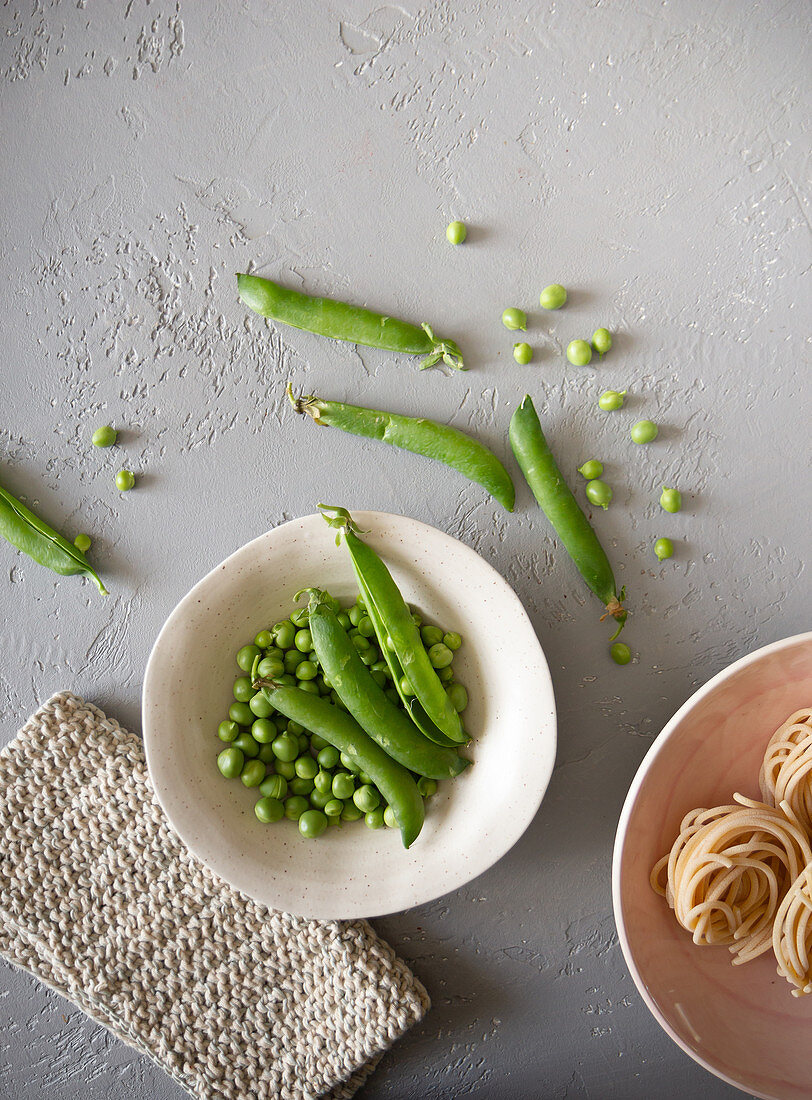 An arrangement of peas and pea pods