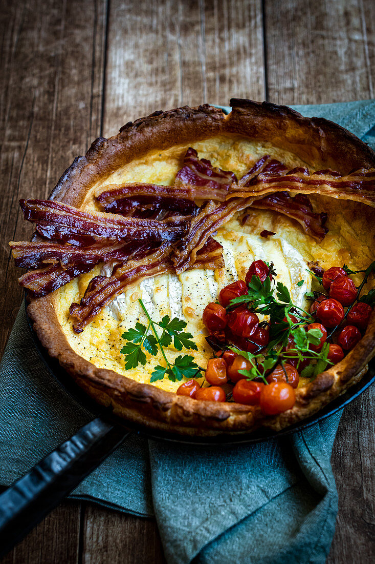 Two cheese 'Dutch Baby' with camembert, bacon and tomatoes