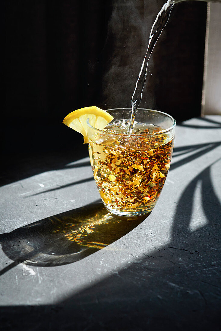 Boiling water being poured over fruit tea