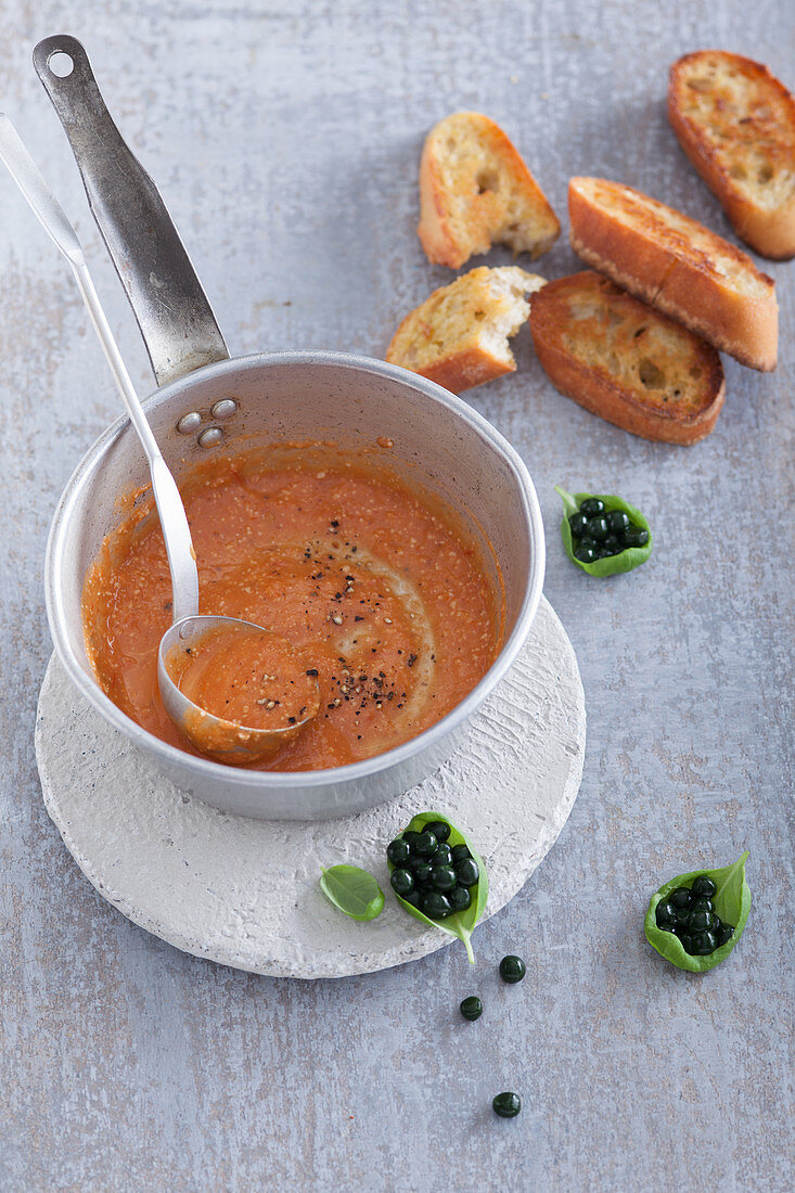 Tomato and orange juice soup with chlorella 'caviar'