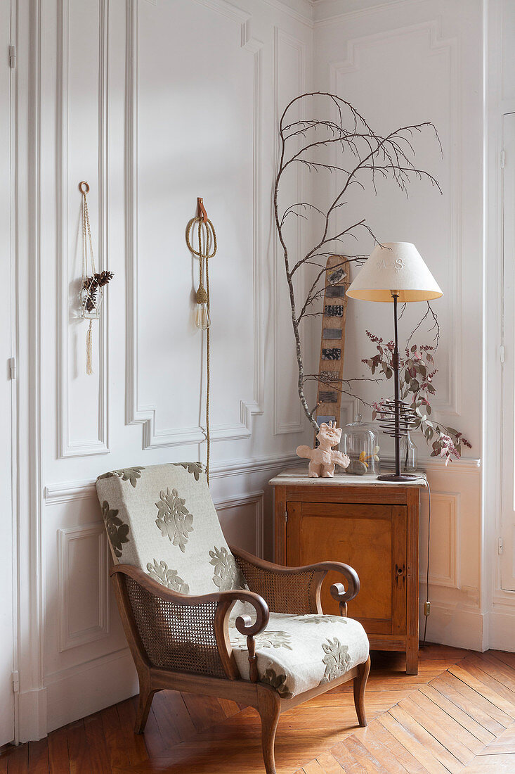 Armchair and wooden cabinet in corner