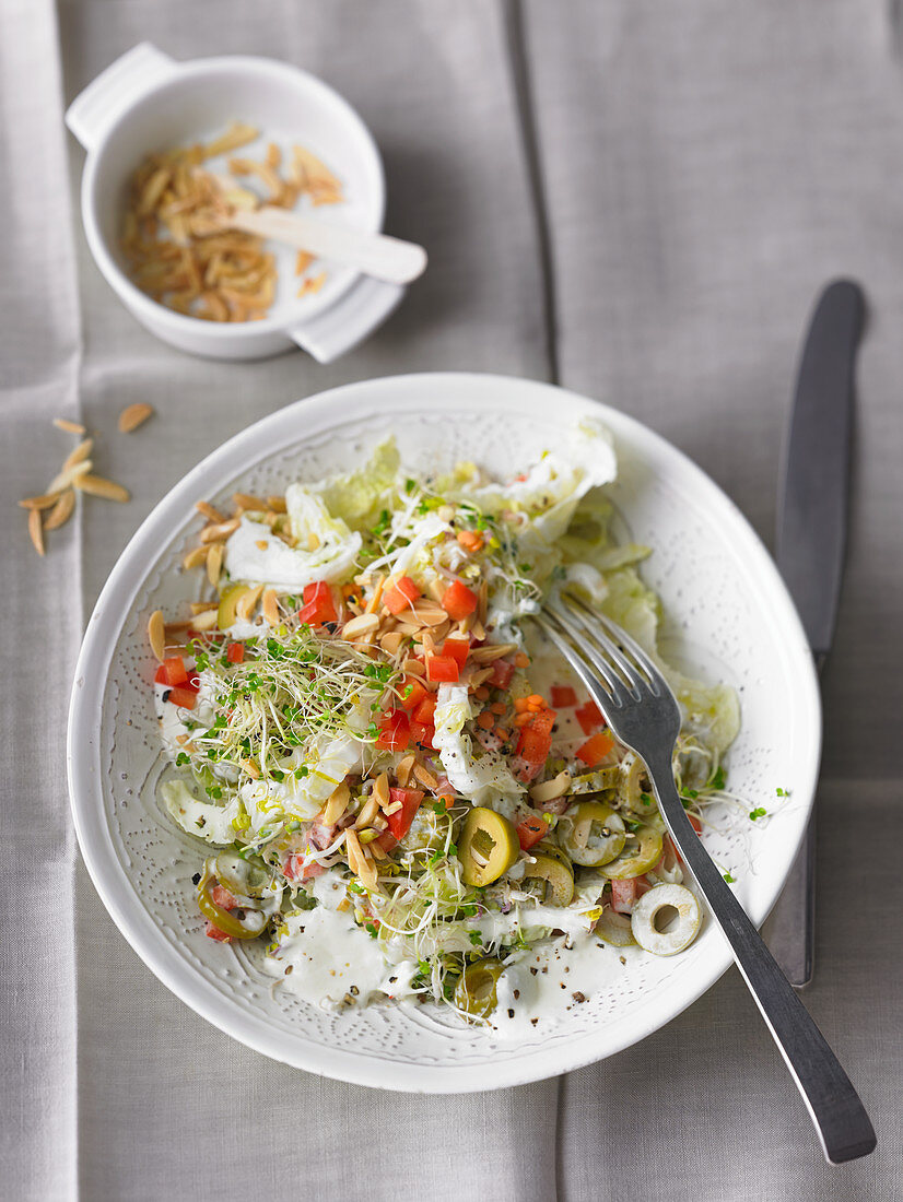 Chinese cabbage salad with olives, beansprouts and almonds