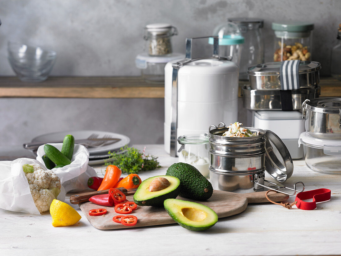 An arrangement of chopped vegetables and kitchen utensils