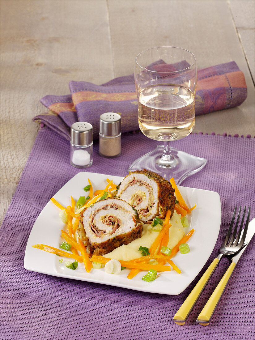 Turkey roulade with a herb crust on a carrot medley