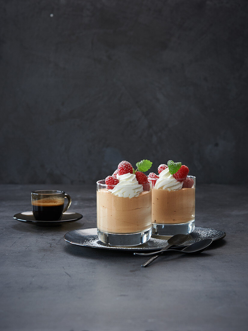 Coffee mousse with whipped cream and raspberries