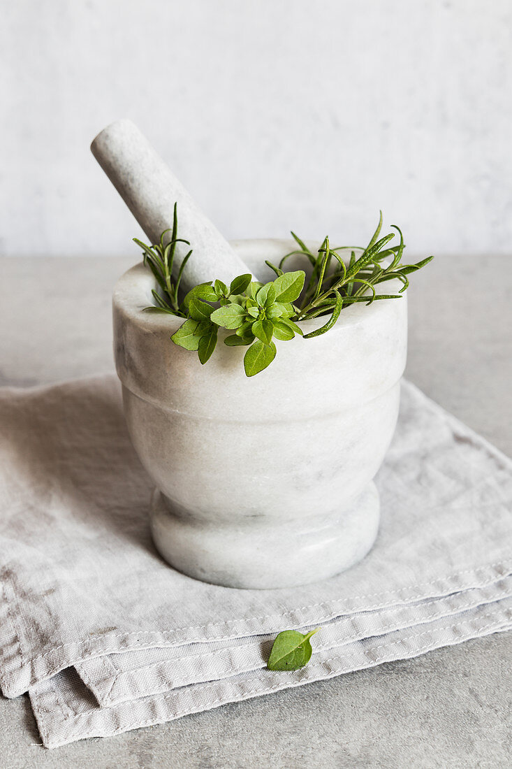 Green herbs in mortar