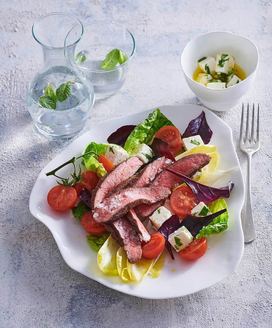 Salad with flank steak and marinated cheese