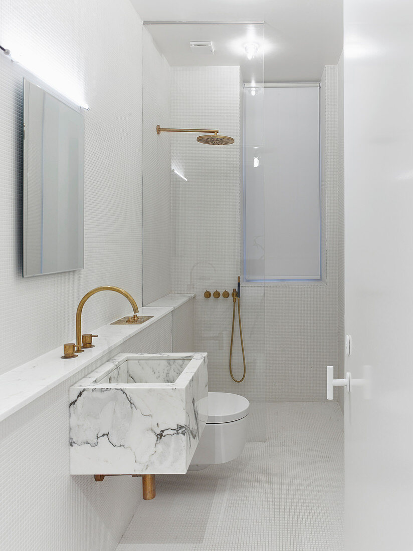 Marble sink and walk-in shower in white, modern, minimalist bathroom
