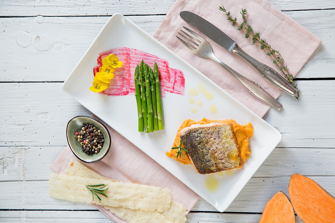 Roasted salmon trout with sweet potato puree and green Thai asparagus