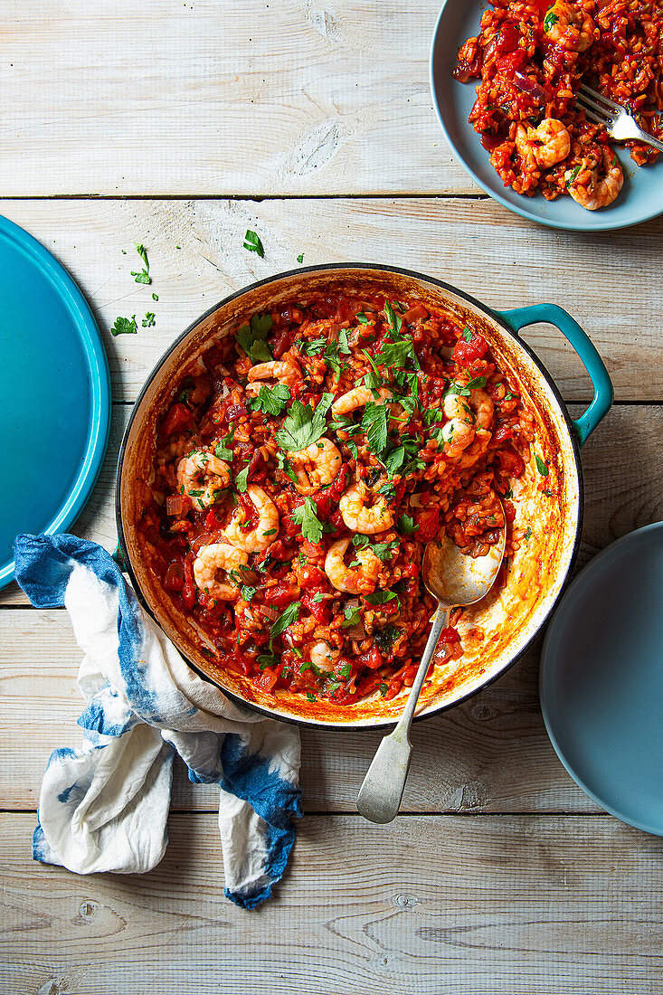 Baked risotto rice with tomatoes, garlic, parsley and lemon garlic prawns