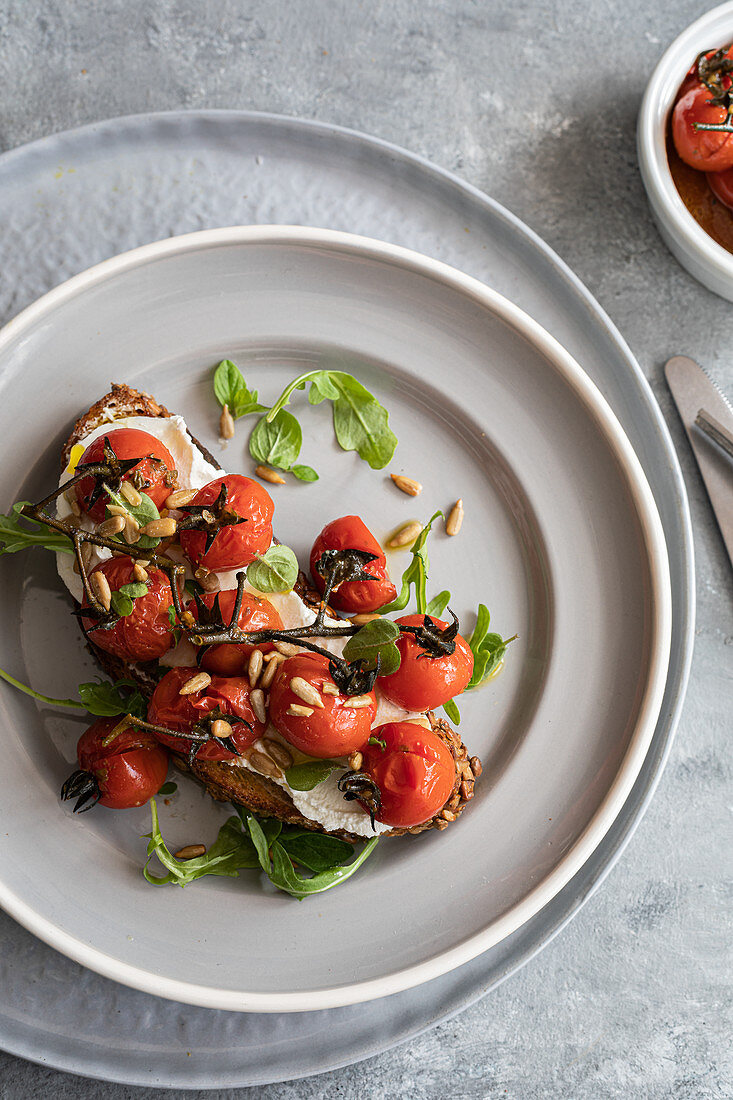 Toast, burrata and tomatoes on the vine roasted