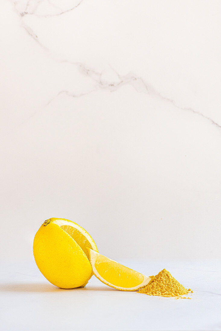 Lemon with wedge and lemon fruit powder