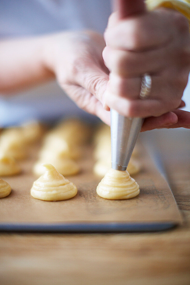 Batter being piped onto baking paper