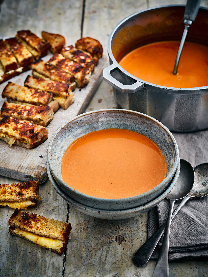 Creamy tomato soup with cheese and Marmite dippers