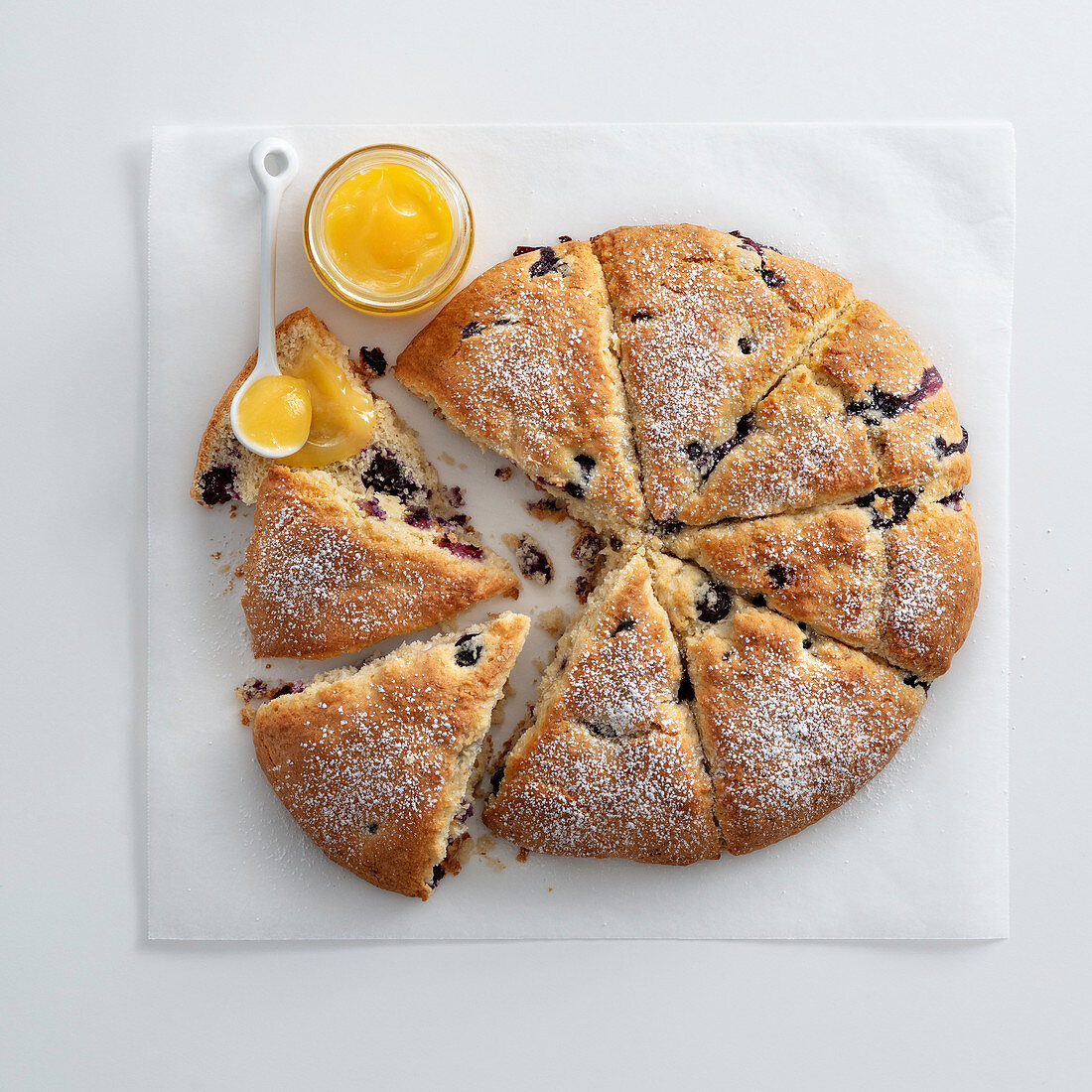 A fruit scone cake with coconut and blueberries