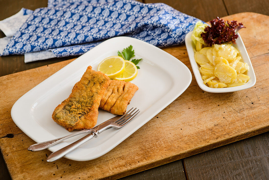 Baked carp with potato salad