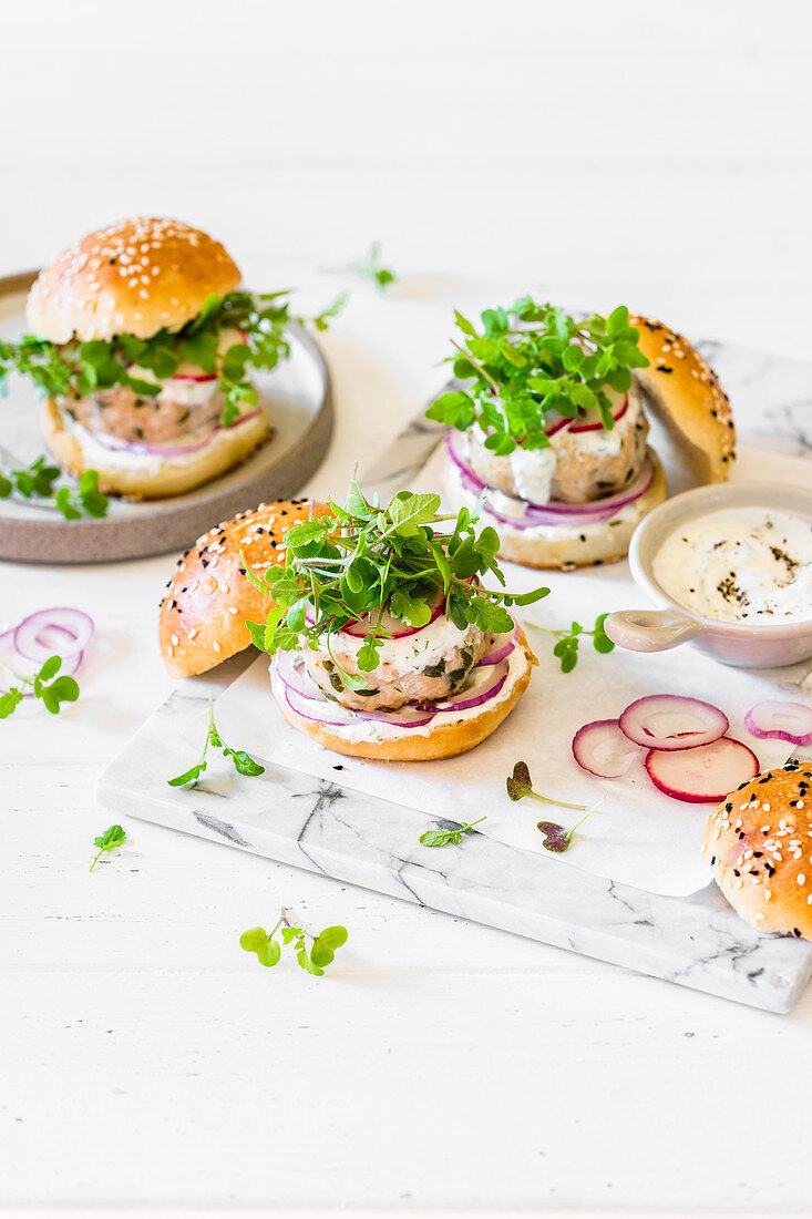 Chicken patty burgers with red onion, radish, microgreen mustard and yoghurt sauce