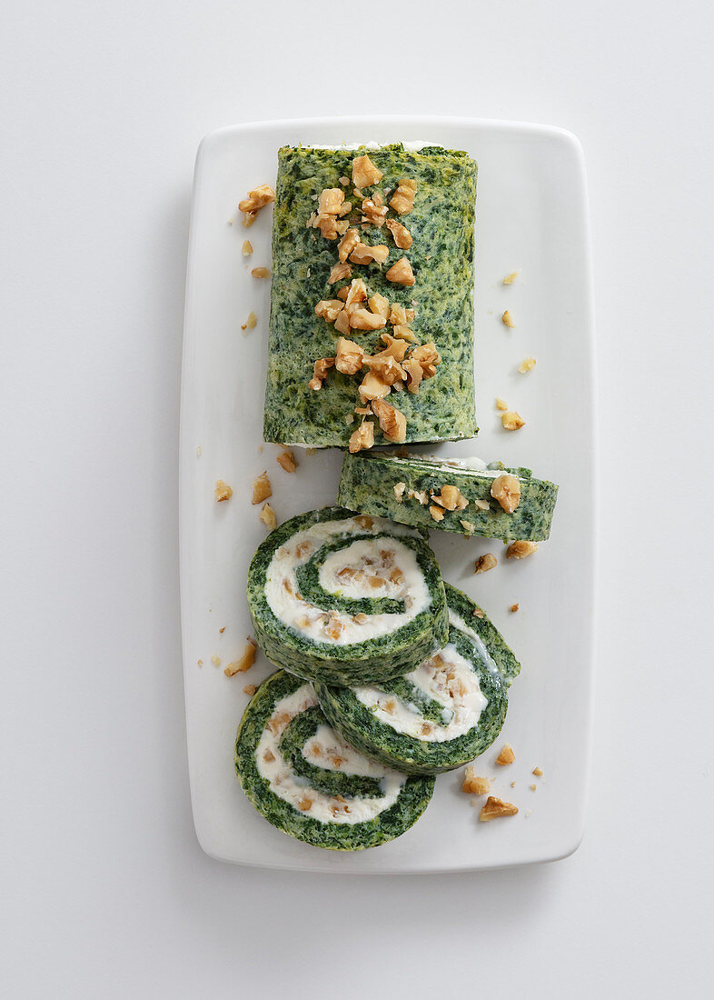 Herb and spinach roll filled with goat's cream cheese and walnuts