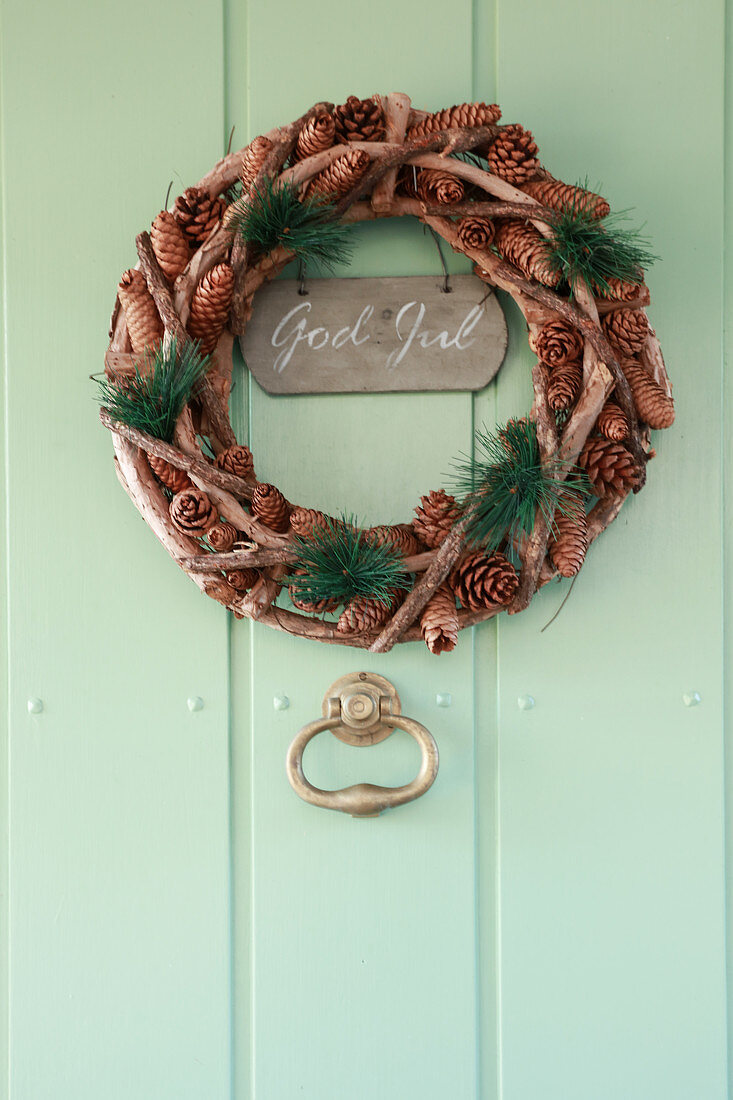 Christmas wreath on green wooden door
