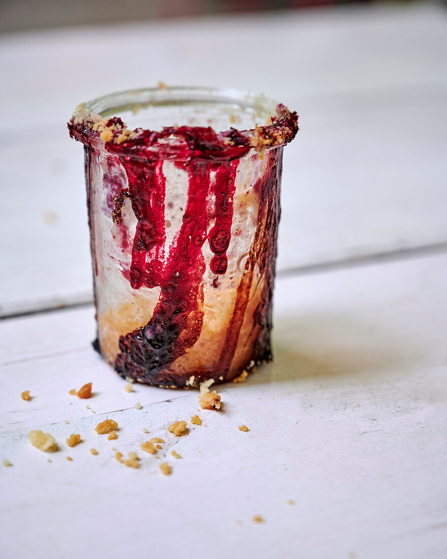 Remnants of crumble with cherries and cassis in the glass