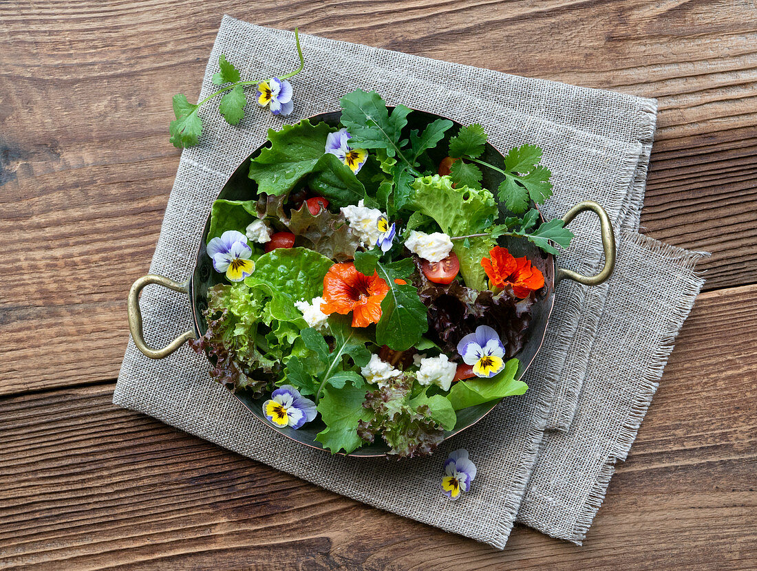 Mixed lettuce with edible flowers and feta