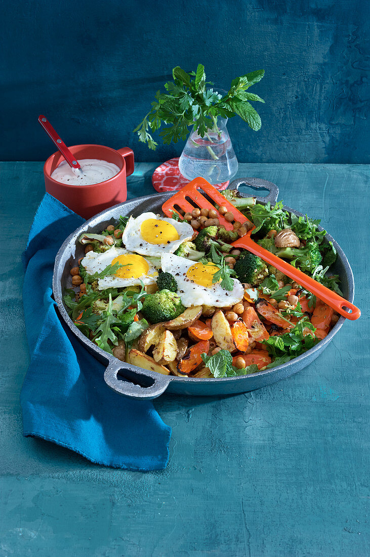Oven-roasted vegetable salad with fried eggs