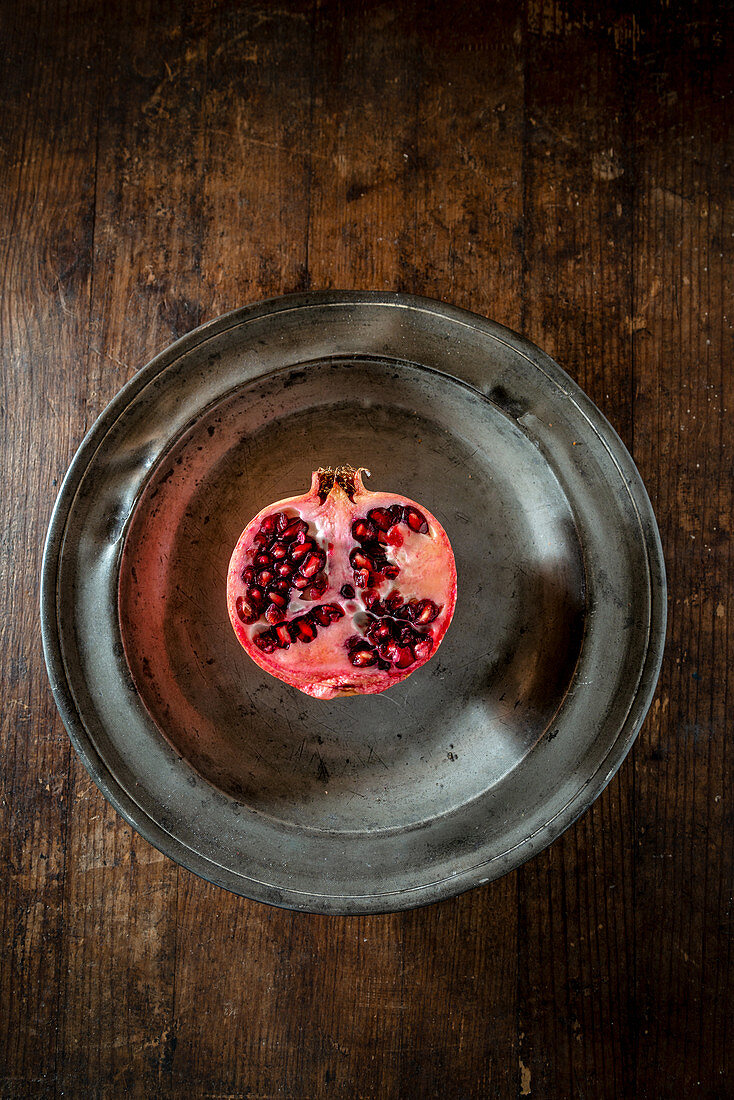 Half pomegranate on a metal plate