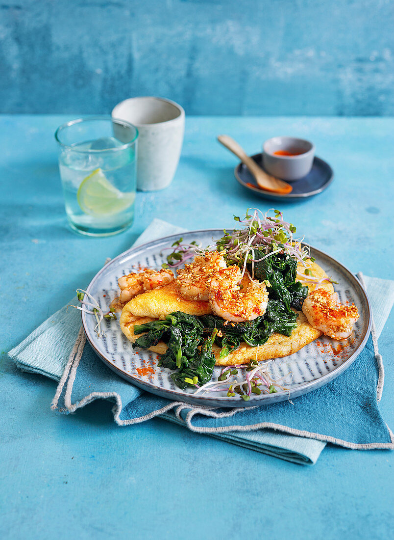 A fluffy omelette with sesame seed prawns, spinach and bean sprouts