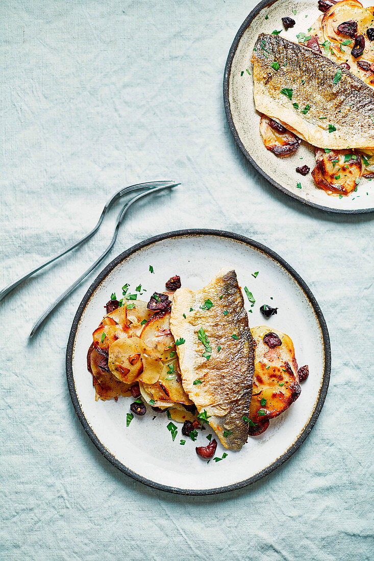 Sea bass with crispy potato and black olive traybake