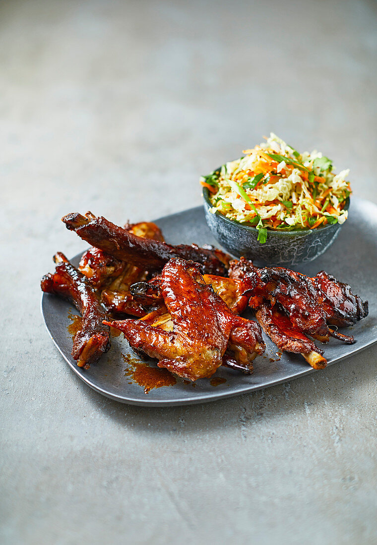 Sticky five-spice ribs and wings with sesame slaw