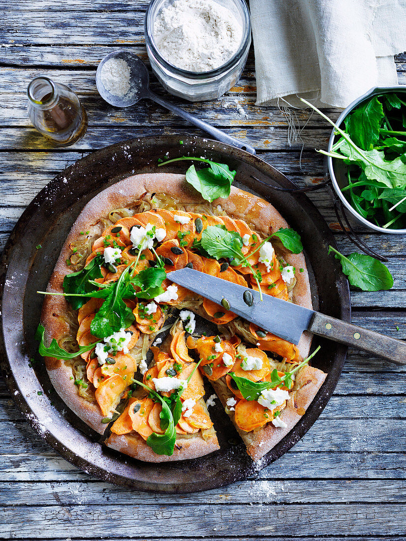 Vegeterian spelt pizza with orange sweet potato, pepitas and goat's cheese