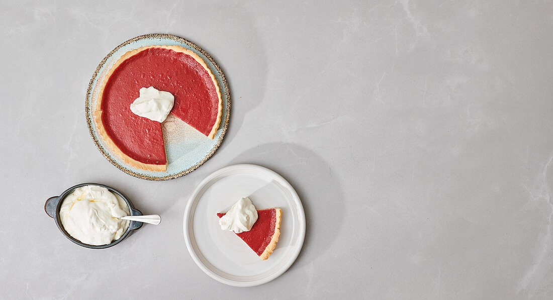 Cranberry pie, cut and served with cream