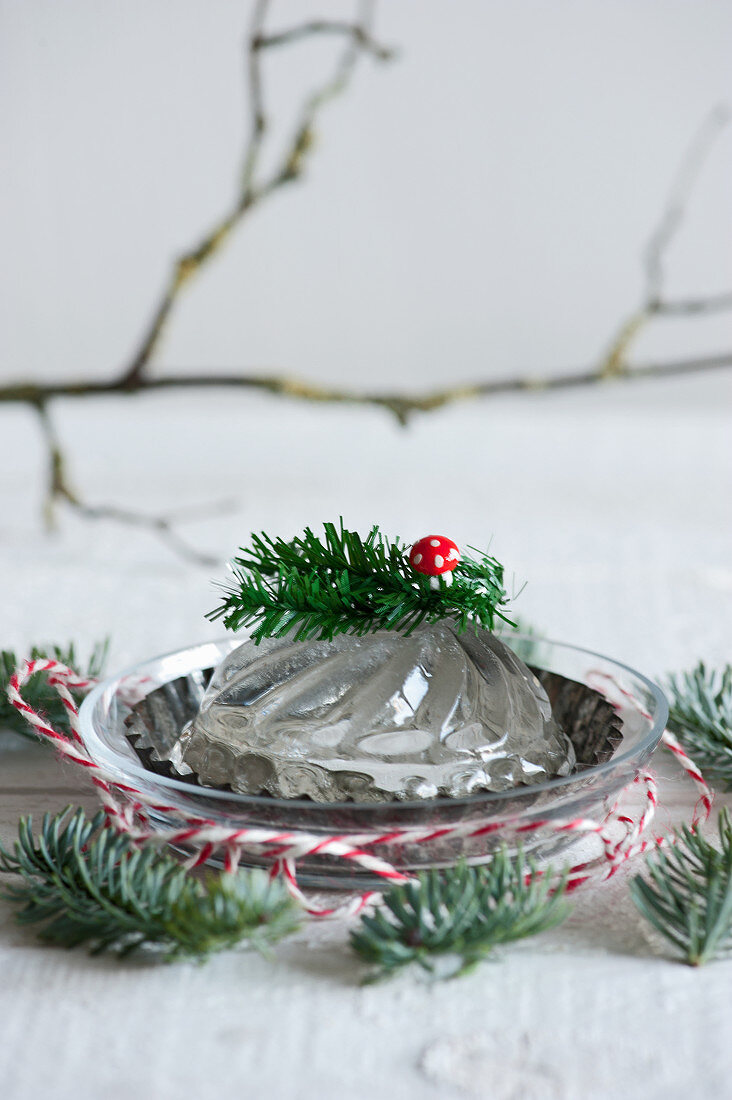 Gelatine in a bundt form as a decoration with fly agaric and twigs