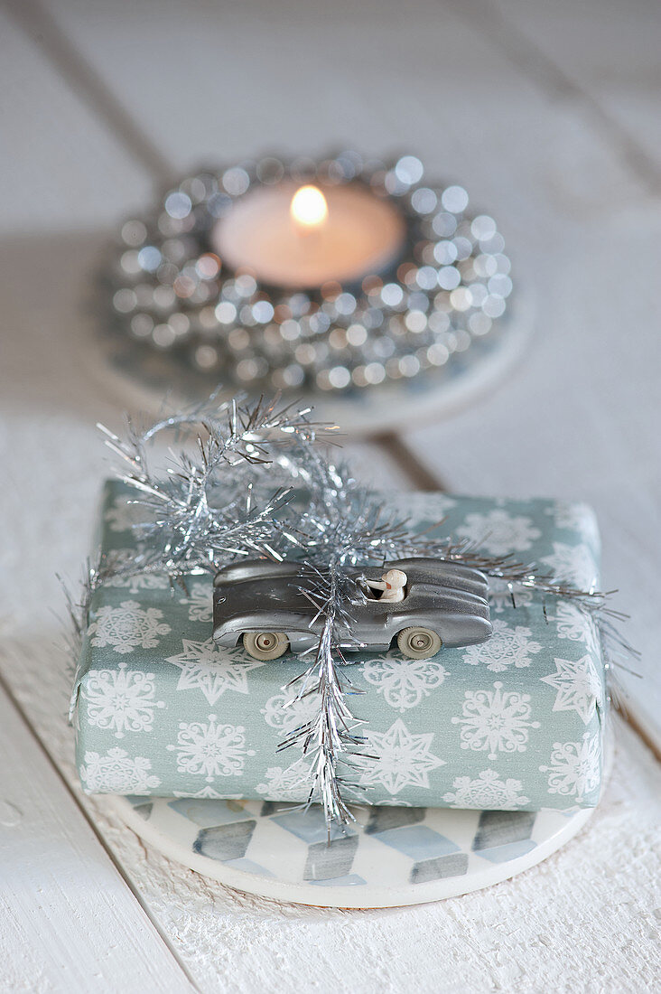 Christmas present with a silver racing car as decoration