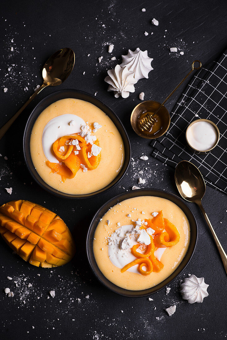 Creamy mango smoothie bowl with meringues