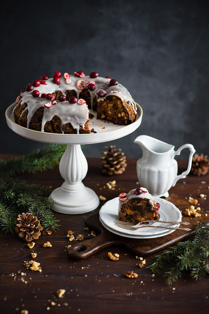 Fruit based Christmas English pudding with topping and cranberries