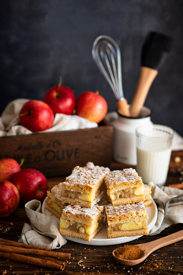 Sliced apple pie with glass of milk and apples