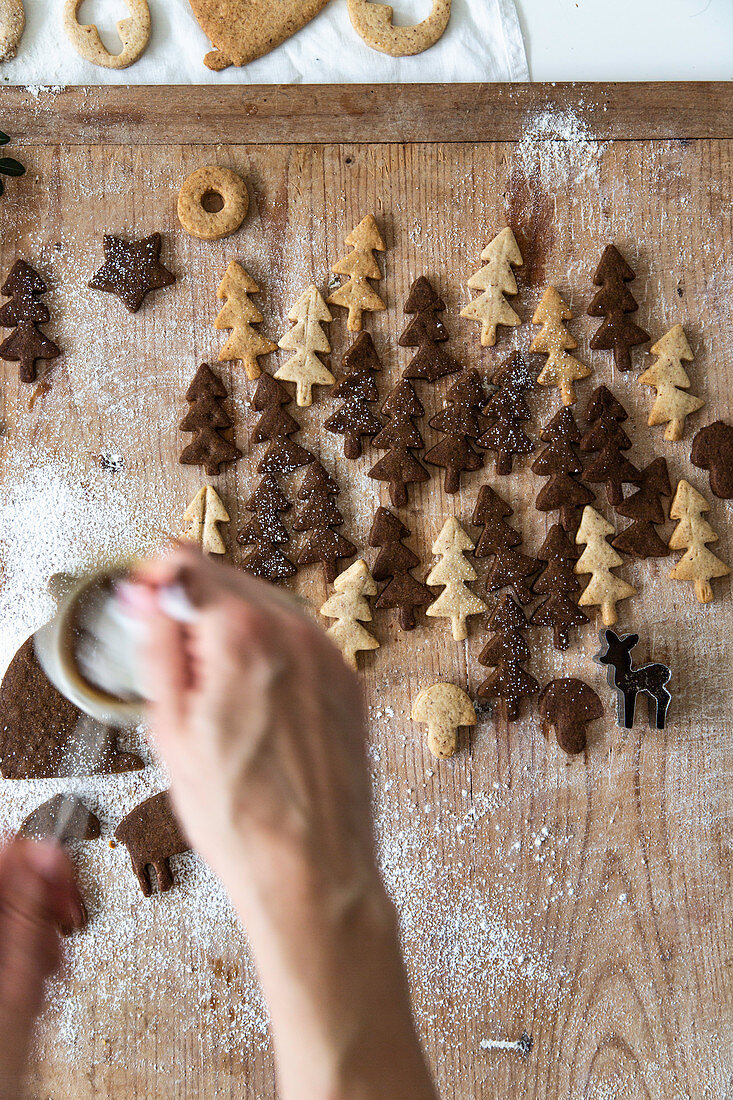 Decorating biscuits shaped like Christmas trees