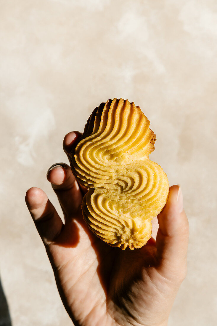 Vanilla butter cookie in hand