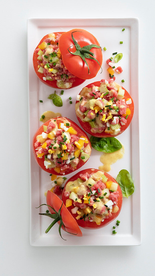 Tomatoes filled with vegetable and beef tartare