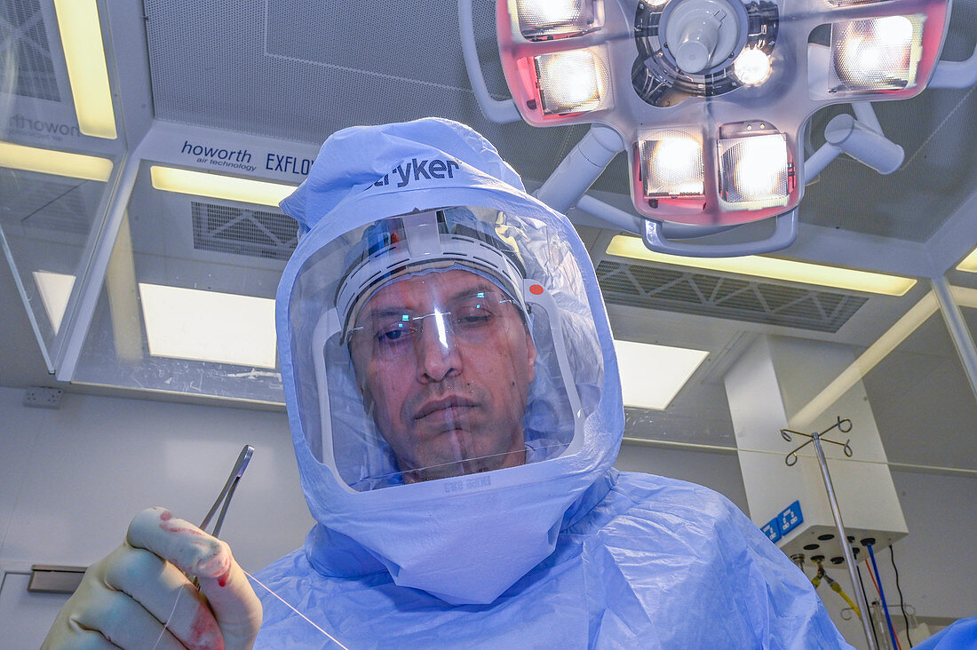 Surgeon wearing surgical hood