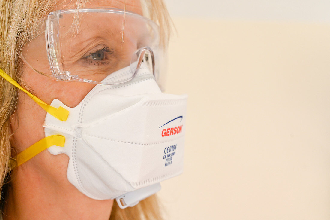 Woman wearing face mask and safety glasses