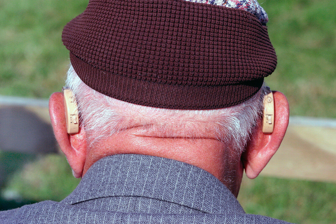 Elderly man wearing hearing aids