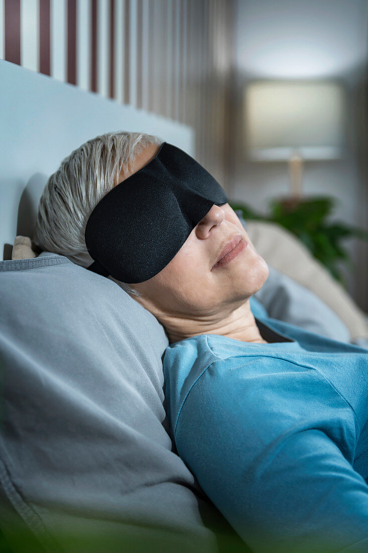 Mature woman wearing black sleep mask