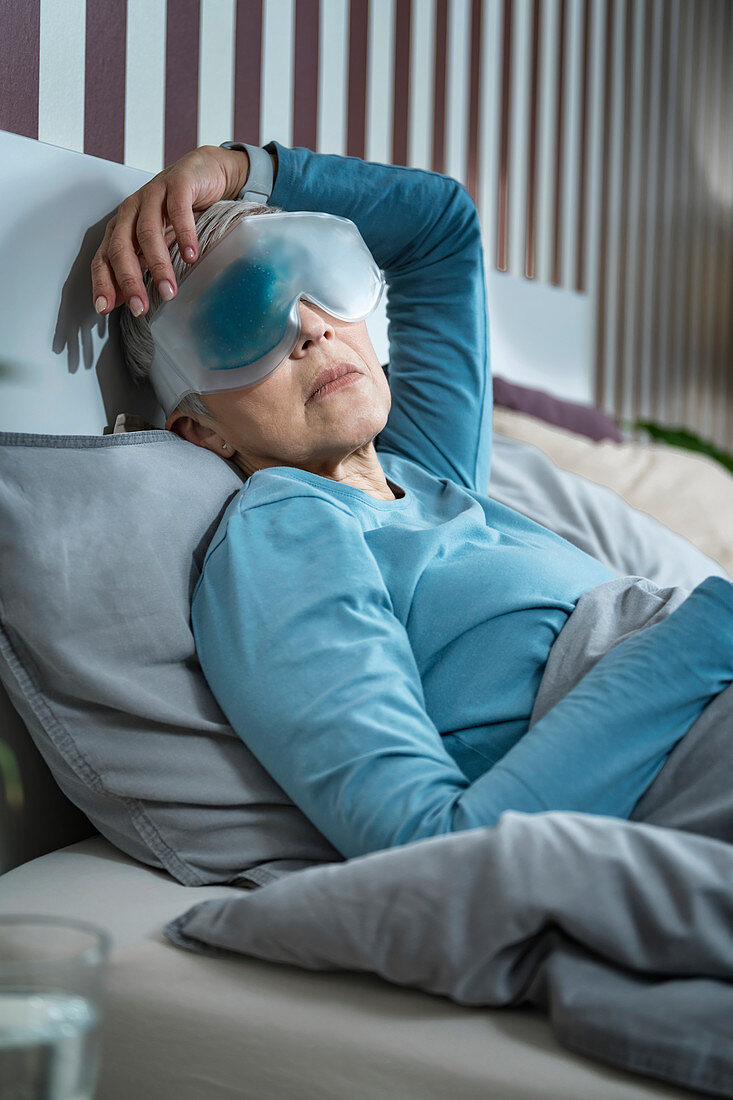Mature woman wearing cooling eye mask