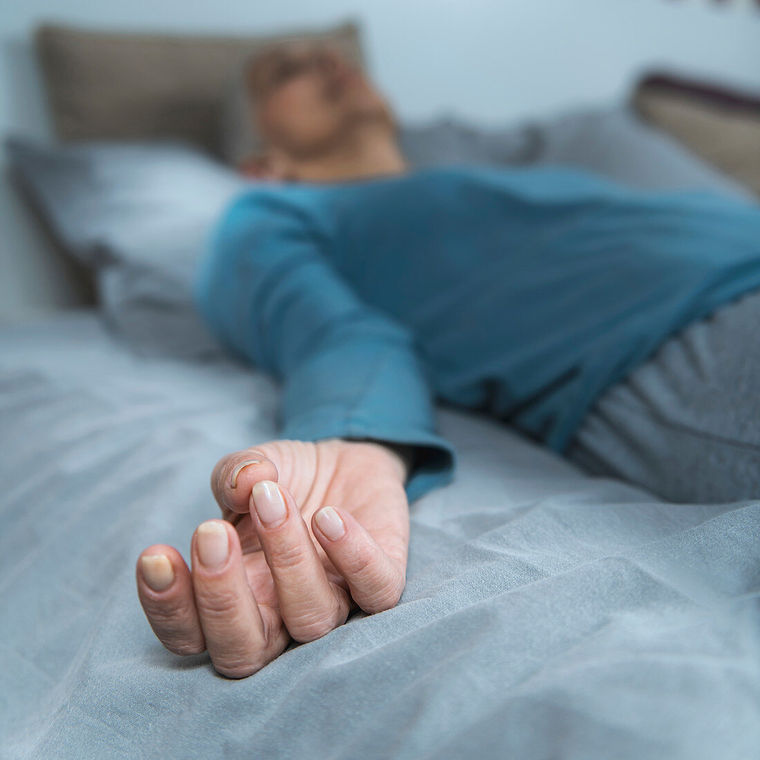 Woman lying in bed meditating